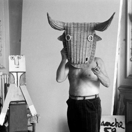 Picasso with a bull wicker mask originally intended for bullfighters' training, he becomes a living Minotaur. Beside him is a sculpture made of scrap wood with the features painted on it. La Californie, Cannes 1959